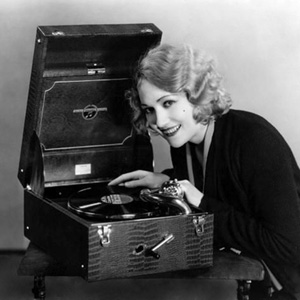 Edwina Booth plays a record on her nifty portable record player, 1930s 78 RPM Edwina Booth plays a record on her nifty portable record player 1930s